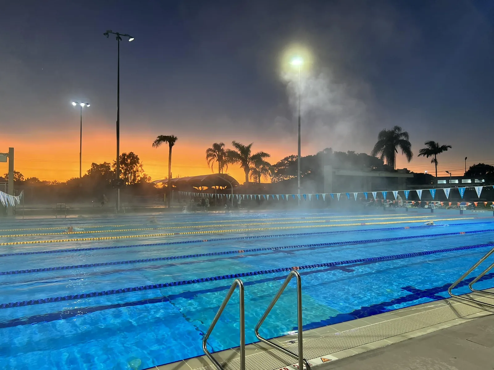 Outdoor 50m pool at Miami Aquatic Centre at dusk